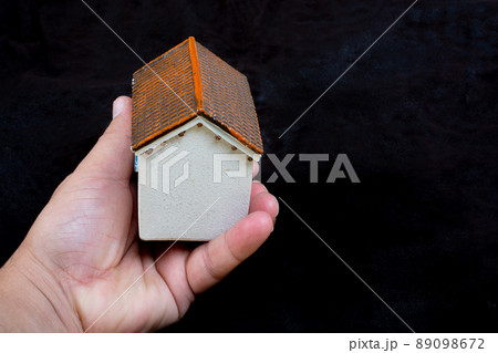 Boy with model house in hand as Property and insurance concept Boy with model house in hand as Property and insurance concept 89098672