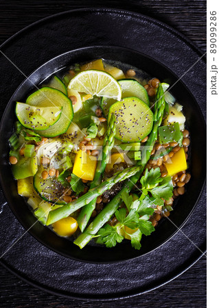 alkaline green soup in black bowl, top view 89099286