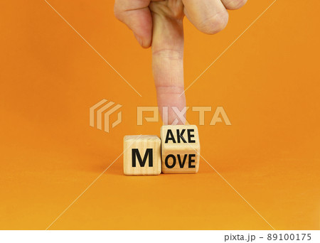 Make your move symbol. Businessman turns the wooden cube with words 'Make move'. Beautiful orange background. Make your move and business concept. Copy space. 89100175