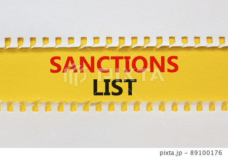 Sanctions list symbol. Yellow and white paper with concept words Sanctions list on beautiful white background. Business political sanctions list concept. Copy space. 89100176