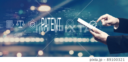 Patent concept with businessman using a tablet 89100321