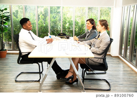 Aviation worker interviewing male job applicants At work on the ground. Aviation worker interviewing male job applicants At work on the ground. 89100760