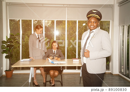 A flight attendant poses in his own workplace. 89100830