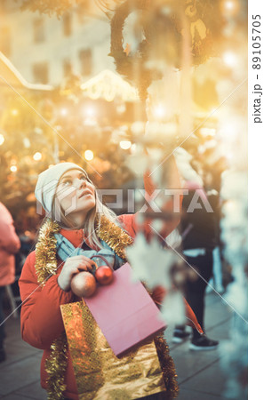 Girl shopping Christmas decorations 89105705