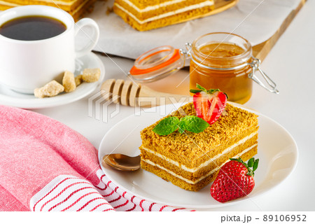 Tasty dessert honey cake. Slice of layered honey cake. Tasty dessert honey cake. Slice of layered honey cake. 89106952