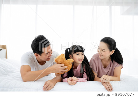 Happy asian family people leisure in bedroom together Happy asian family people leisure in bedroom together 89107077