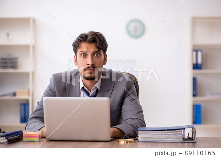Young male employee sitting in the office 89110165
