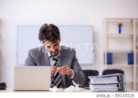 Young businessman employee suffering at workplace 89110526