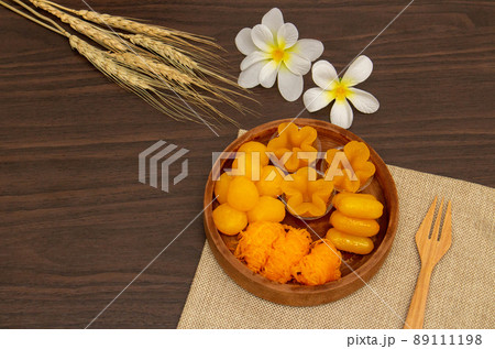 Thai traditional dessert concept, Thong Yip Thong Yod Foi Thong and jackfruit seeds in wood bowl 89111198