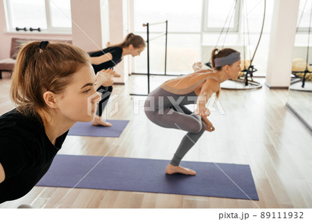 Women exercising in fitness studio yoga classes, sport and health concept 89111932