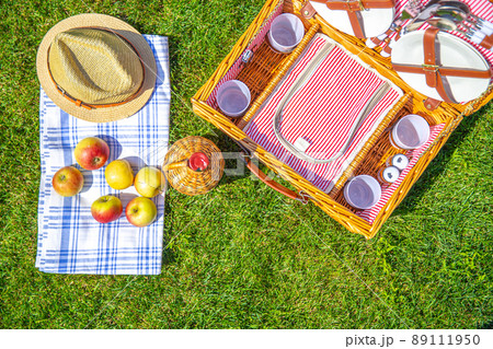 Green lawn with pic nic concept. Set of glasses and plates Green lawn with pic nic concept. Set of glasses and plates 89111950