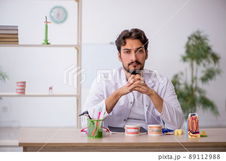 Young male dentist working in the clinic Young male dentist working in the clinic 89112988