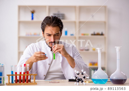 Young male chemist working at the lab Young male chemist working at the lab 89113563