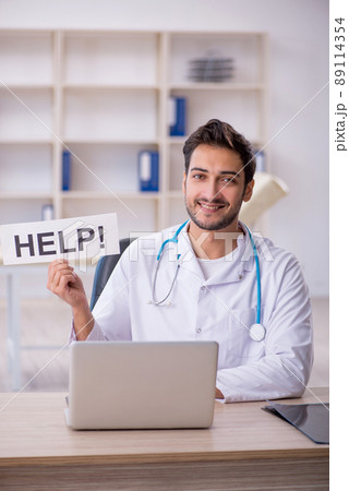 Young male doctor working in the clinic Young male doctor working in the clinic 89114354