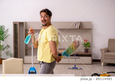 Young man doing housework at home Young man doing housework at home 89114485