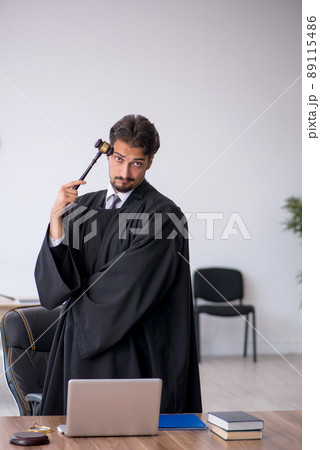 Young male judge working in the courthouse 89115486