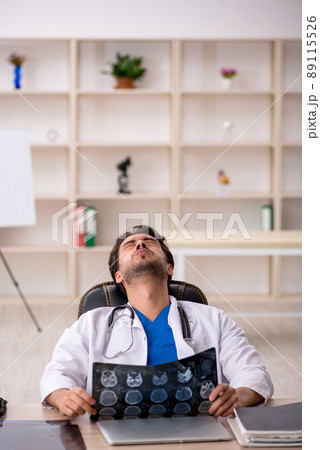 Young male doctor radiologist working in the clinic Young male doctor radiologist working in the clinic 89115526