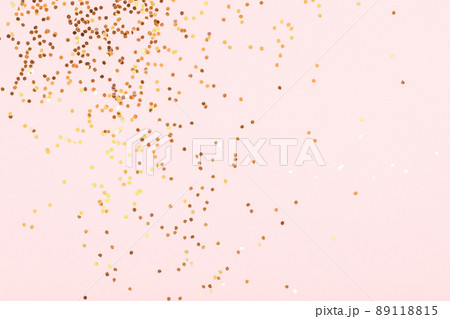 Golden confetti on pink background. Golden confetti on pink background. 89118815