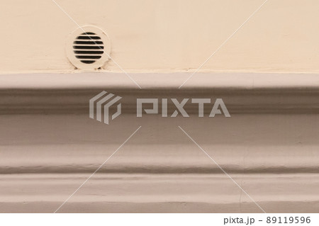 Small old ventilation window facing the outside of the street on the wall background 89119596