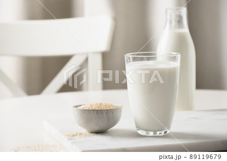 Sesame milk on white kitchen background. Lactose free. Close up. Lack of cholesterol. Sesame milk on white kitchen background. Lactose free. Close up. Lack of cholesterol. 89119679