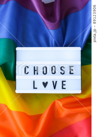Rainbow flag with lightbox and text CHOOSE LOVE. Rainbow lgbtq flag made from silk material. Symbol of LGBTQ pride month. Equal rights. Peace and freedom Rainbow flag with lightbox and text CHOOSE LOVE. Rainbow lgbtq flag made from silk material. Symbol of LGBTQ pride month. Equal rights. Peace and freedom 89123906