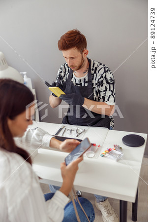 Busy woman client visiting modern manicure salon Busy woman client visiting modern manicure salon 89124739