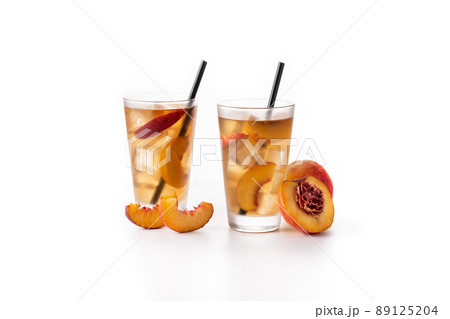 Glass of peach tea with ice cubes Glass of peach tea with ice cubes 89125204