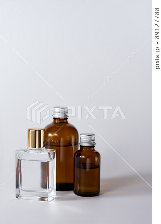 透明ガラスの化粧品ボトルと茶色いボトル 89127788