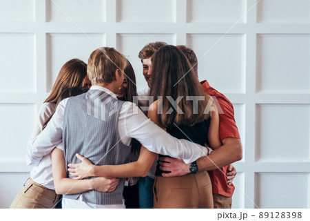 Psychological support, people are standing in circle and hugging. 89128398