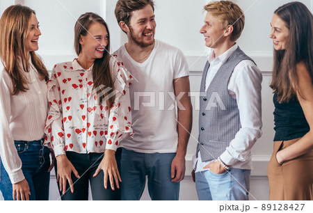 Portrait of young people standing together and smiling. Portrait of young people standing together and smiling. 89128427