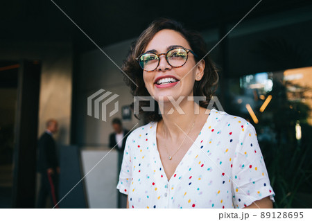 Smiling woman in eyeglasses near office 89128695