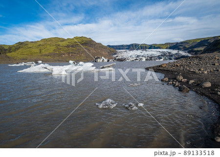 Skaftafellsjokull glacier, Iceland. Glacier tongue slides from the Vatnajokull icecap or Vatna Glacier near subglacial Esjufjoll volcano. Glacial lagoon with blocks of ice and surrounding mountains. 89133518