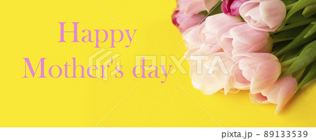 Tulip spring flowers, mother's day banner, tulip bouquet on yellow background with copy space Tulip spring flowers, mother's day banner, tulip bouquet on yellow background with copy space 89133539