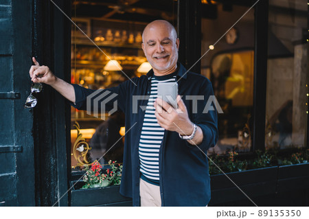 Aged man with smartphone tech using 4g internet for messaging and chatting in social media 89135350