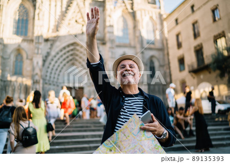 Cheerful Caucaisan man gesturing hand during solo vacations Cheerful Caucaisan man gesturing hand during solo vacations 89135393