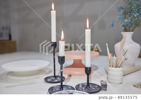 Three candles on the small table covered. Three candles on the small table covered. 89135575