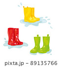 Set of colorful rubber boots in puddle of water 89135766