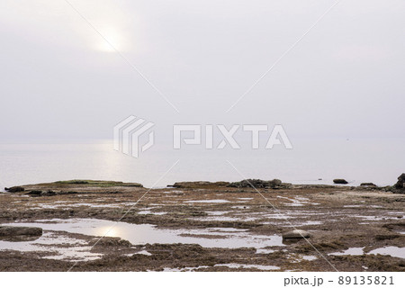 A small fishing boat on the beach in Jaffa, on a foggy day. Concept for peace, quiet and serenity. High key photography 89135821