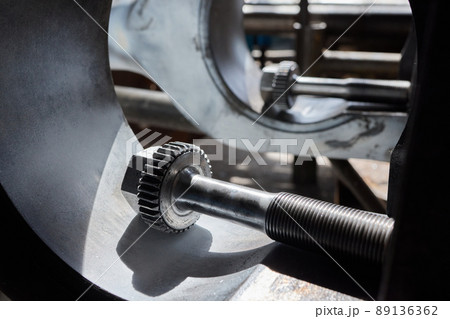 Close up of the CNC lathe jaw clamping raw material steel rod .Steel Cylinder part after turning process. Hi-precision CNC machining concept.Raw material steel rod for CNC lathe precess. 89136362