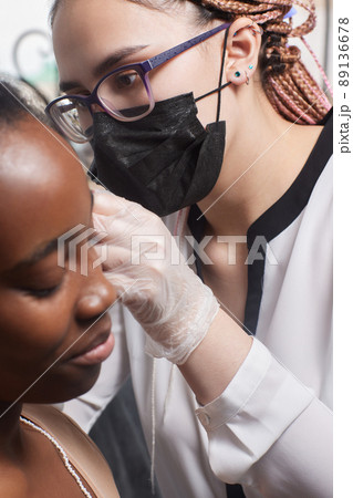 Close up of woman's ear with pierced on her ear for treatment of the pain some place on her body by Chinese doctor. 89136678