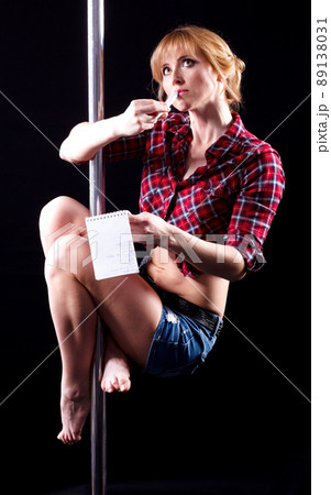 The strong and graceful young girl performing acrobatic exercises on pylon The strong and graceful young girl performing acrobatic exercises on pylon 89138031