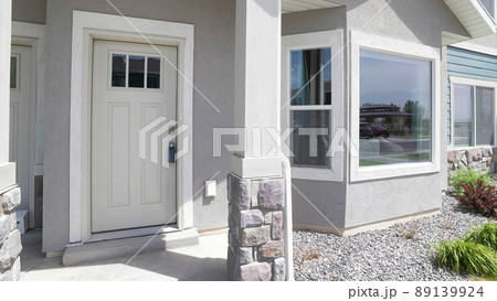 Panorama Townhouse exterior with white front door and bay windows 89139924