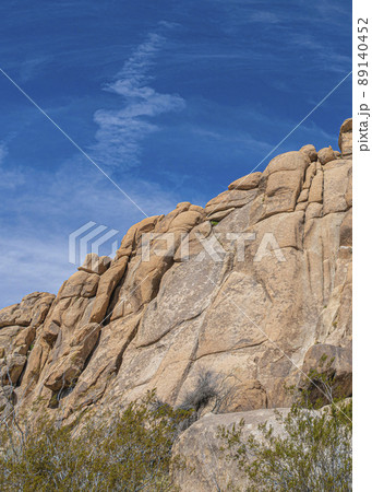 Vertical Low angle view of a rocky mountain against the clear blue sky in a national park in California Vertical Low angle view of a rocky mountain against the clear blue sky in a national park in California 89140452