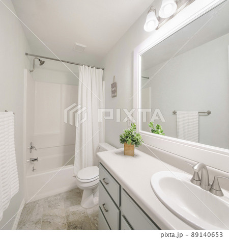 Square Windowless white minimalist bathroom interior with marble tile flooring Square Windowless white minimalist bathroom interior with marble tile flooring 89140653