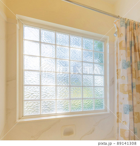 Square Interior of a bathroom with aquatic theme designs on the shower curtain and framed shells Square Interior of a bathroom with aquatic theme designs on the shower curtain and framed shells 89141308