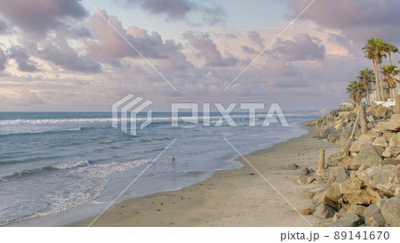 Panorama Puffy clouds at sunset Empty beach with natural rock seawall at Oceanside, California Panorama Puffy clouds at sunset Empty beach with natural rock seawall at Oceanside, California 89141670