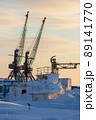 Winter view of the cranes of a small cargo seaport in the far north of Russia in the Arctic 89141770