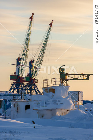 Winter view of the cranes of a small cargo seaport in the far north of Russia in the Arctic Winter view of the cranes of a small cargo seaport in the far north of Russia in the Arctic 89141770