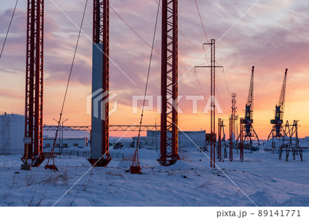 Winter industrial landscape. Morning view of power poles and port cranes. 89141771