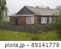 Old wooden house behind a fence 89141778